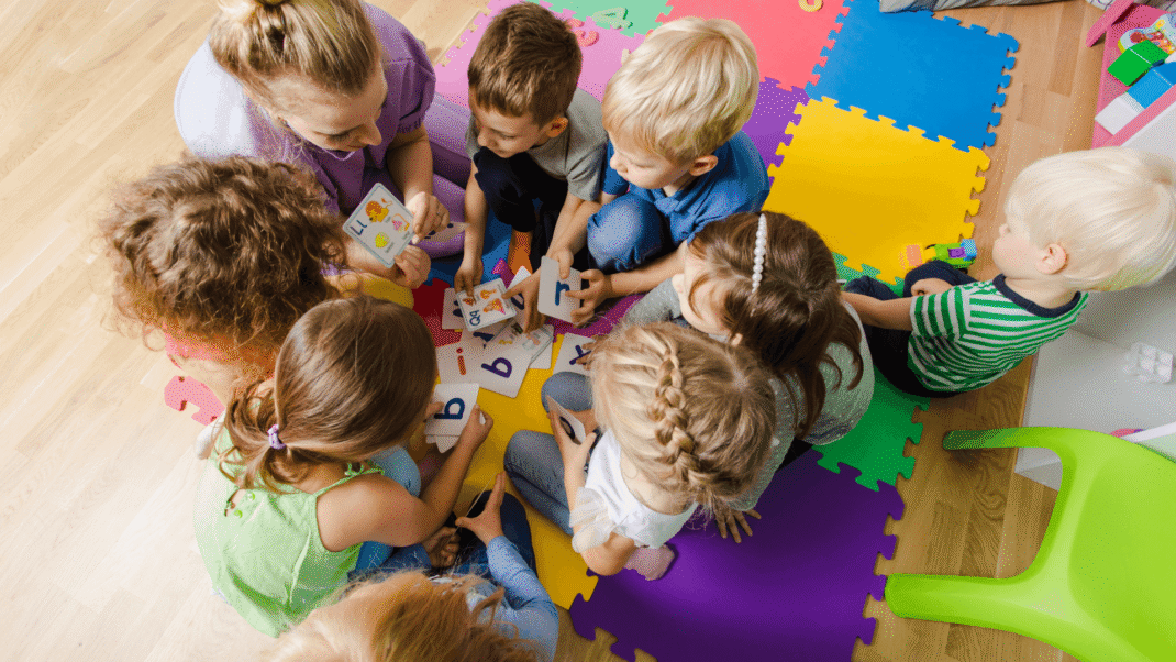 Group of children playing cards.